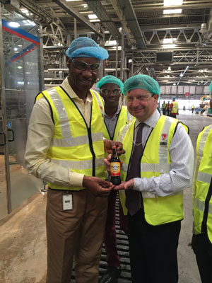 Visit to a beverage manufacturer, pictured with company directors and workers in the bottling plant